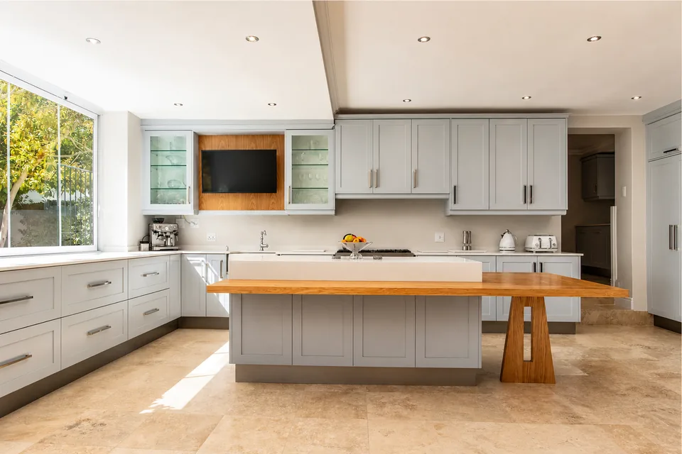 Completed CT Builders kitchen with grey cabinetry and an oak island table